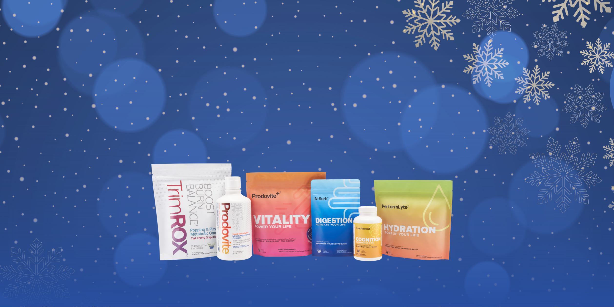 A picture of all VNI products in order from left to right Trimrox, Prodovite, Prodovite+, N-Sorb, Brain Reward, and Performlyte. All of these products are on a blue background with snowflakes and fairy lights.